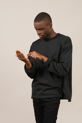 Black man using imaginary smartphone