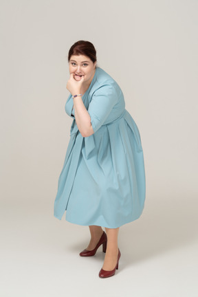 Front view of a woman in blue dress whistling