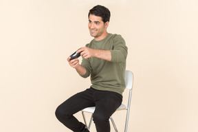 Young caucasian guy playing a videogame