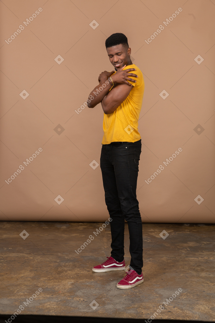 A man in a yellow shirt posing for a picture