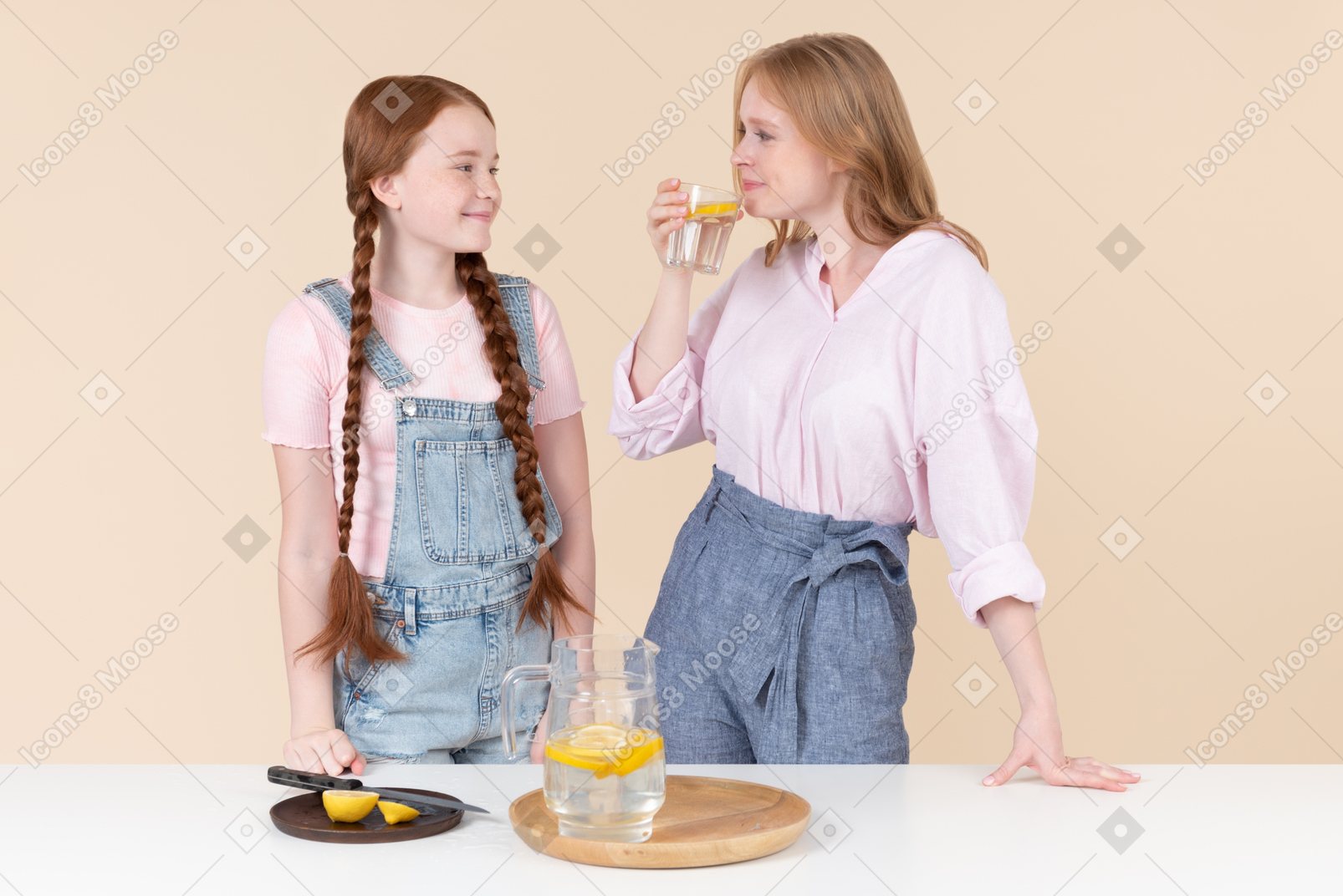 Two young girls drinking lemon water