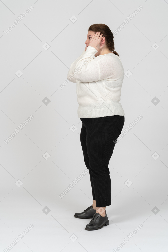 Plump size woman in casual clothes touching head