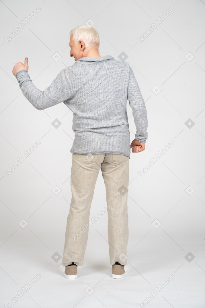 Rear view of man giving thumbs up