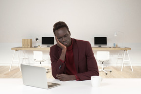 A man sitting in front of a laptop computer