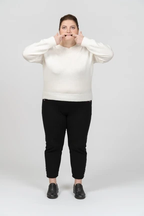 Plump woman in casual clothes making faces