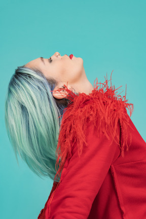 Turquoise haired woman bending backwards