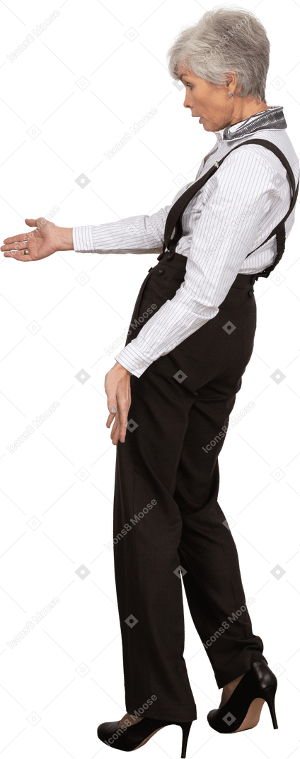 Vista lateral de una anciana interrogante en ropa de oficina extendiendo su mano