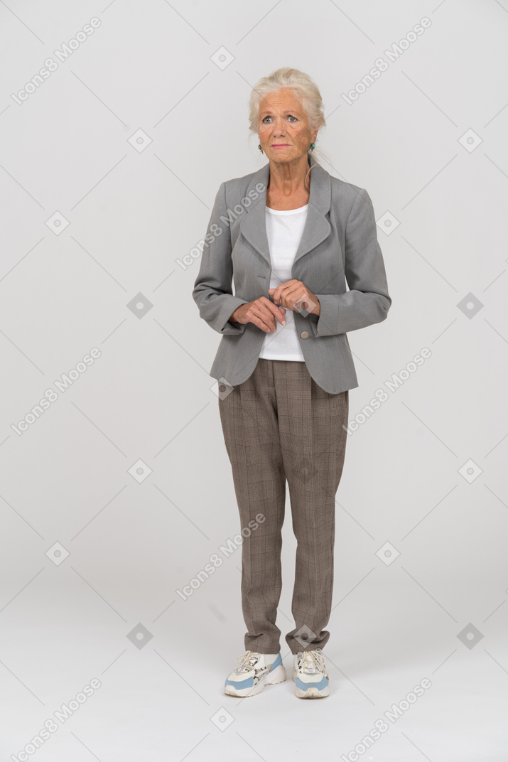 Front view of an upset old lady in suit