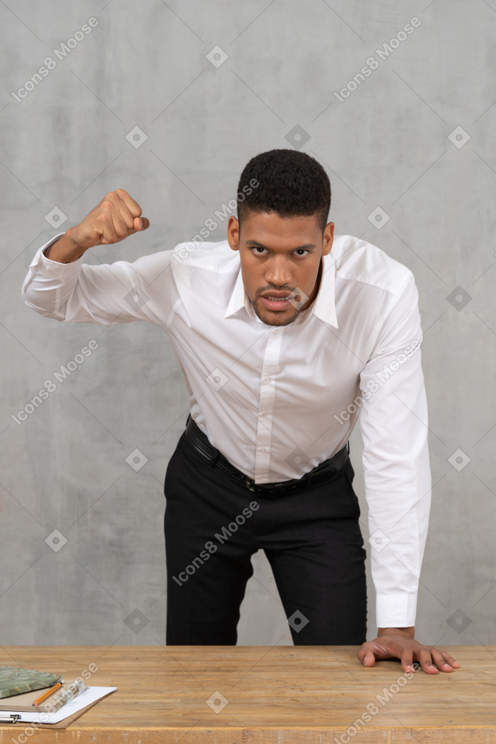 Angry man is ready to punch the table