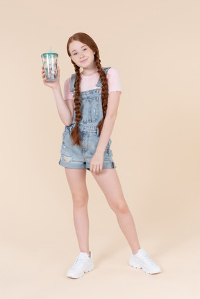 Teenager kid girl holding plastic cup
