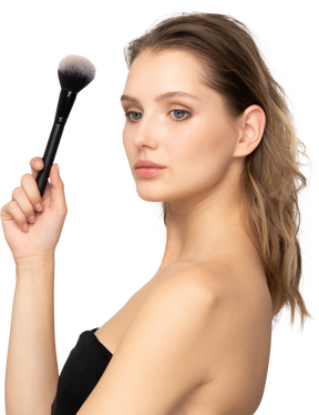 Side view of a sensual young woman holding a make-up brush & looking at camera