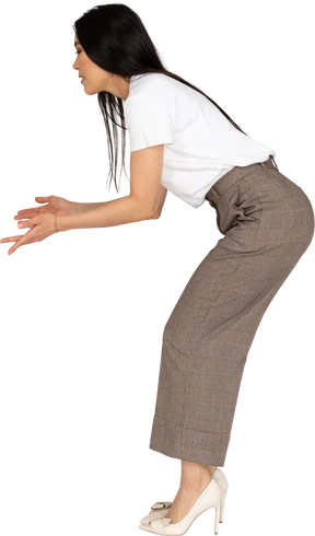 Side view of a questioning young lady in breeches and t-shirt raising hands and bending down