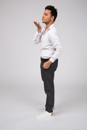 Side view of a man blowing a kiss