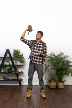 Dehydrated backpacker holding an empty flask