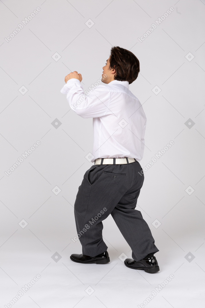 Back view of an office worker raising a fist