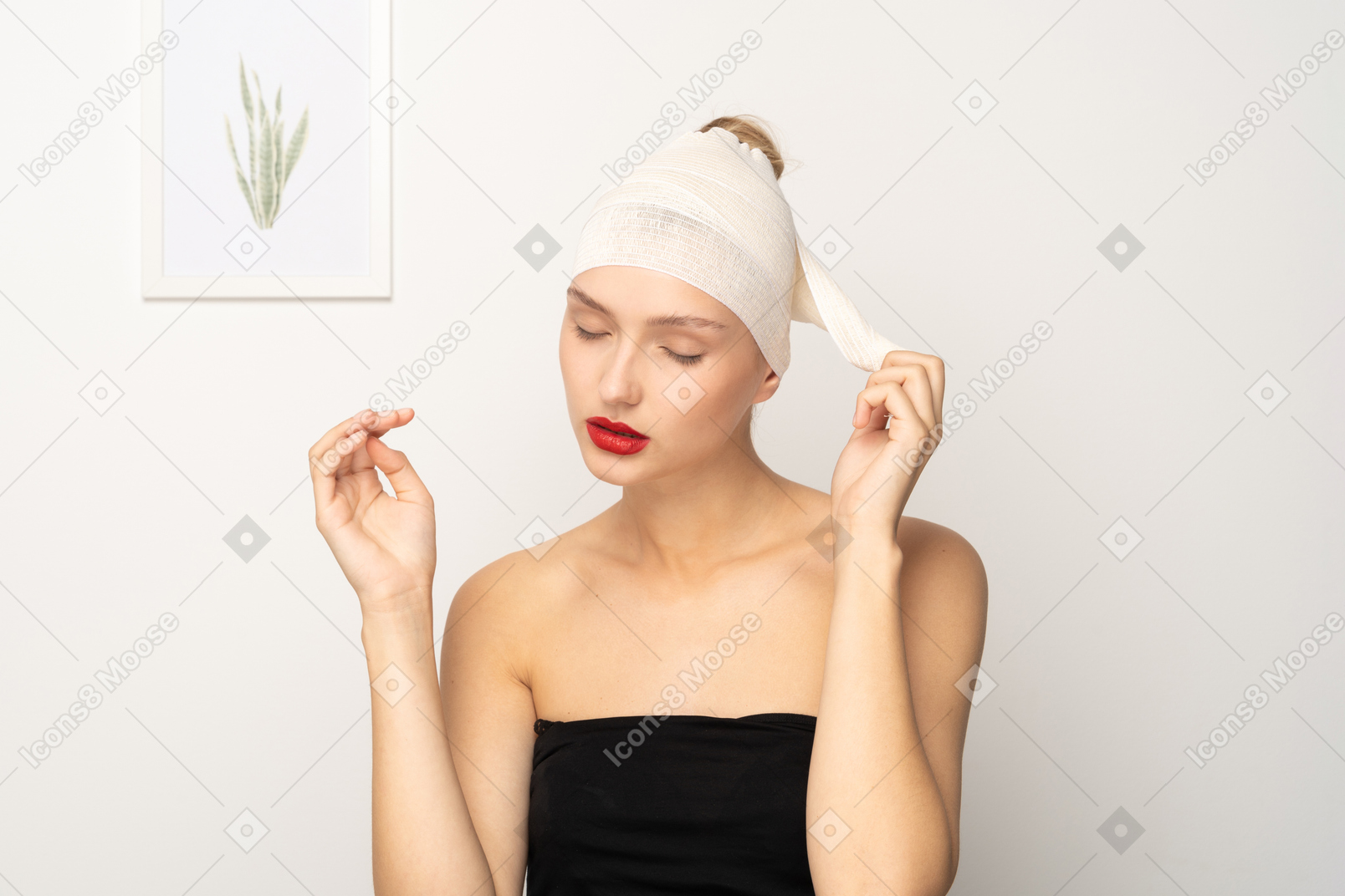 Young woman removing her head bandage