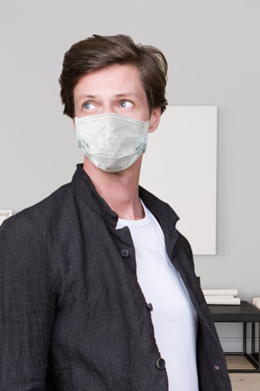 A man wearing a face mask in a room