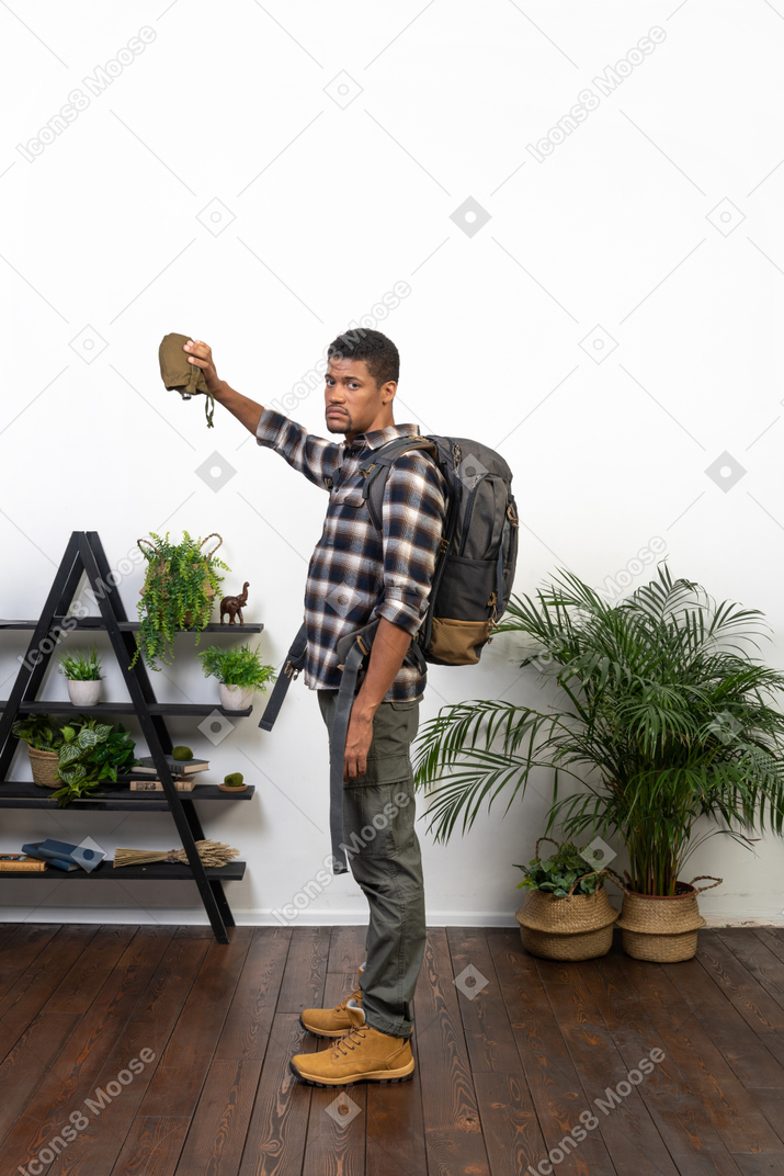 Side view of a thirsty tourist holding an empty flask