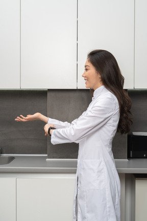 Side view of a smiling female  looking aside and outstretching hand