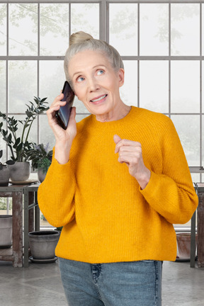 An older woman talking on a cell phone