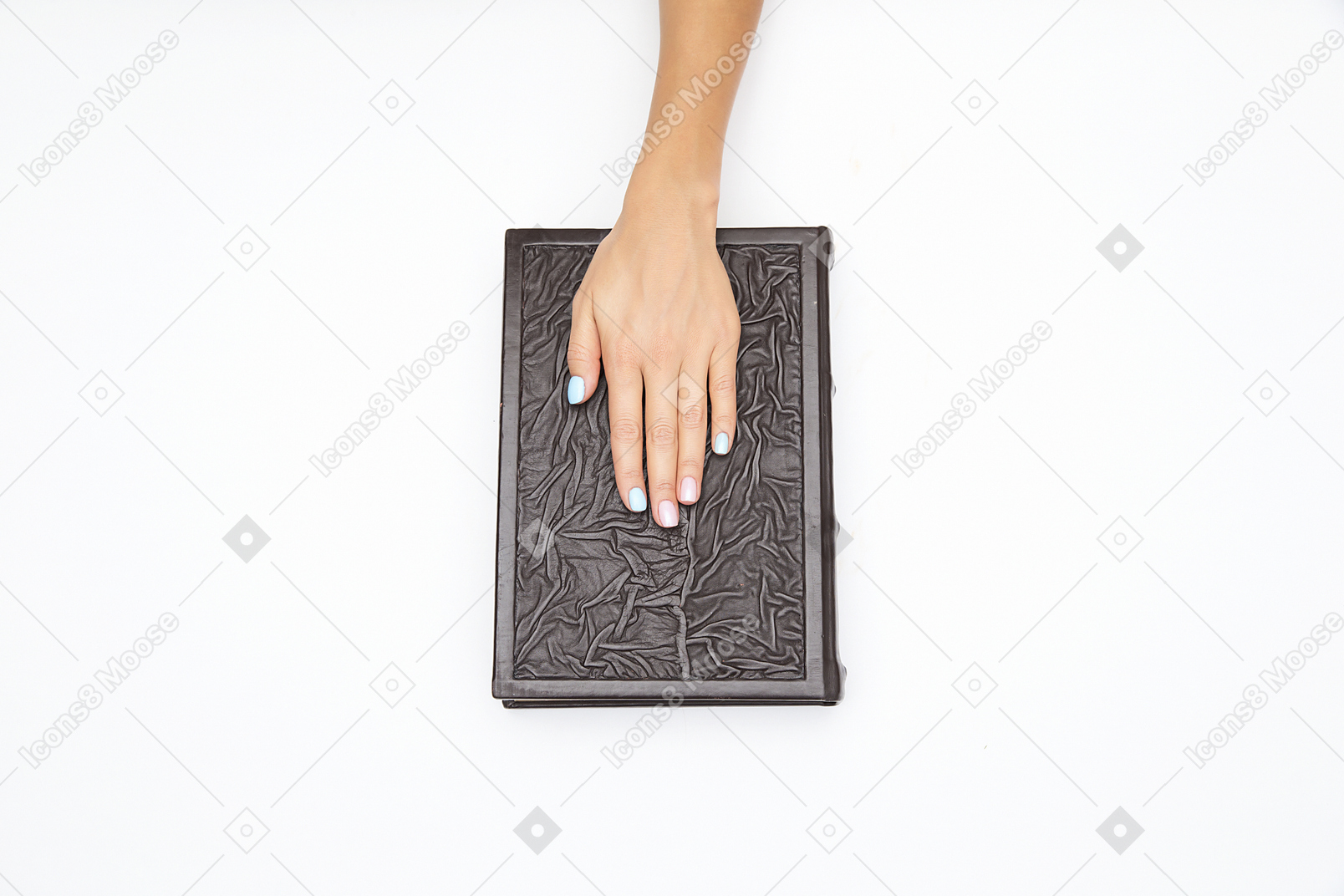 Mãos femininas segurando um livro preto
