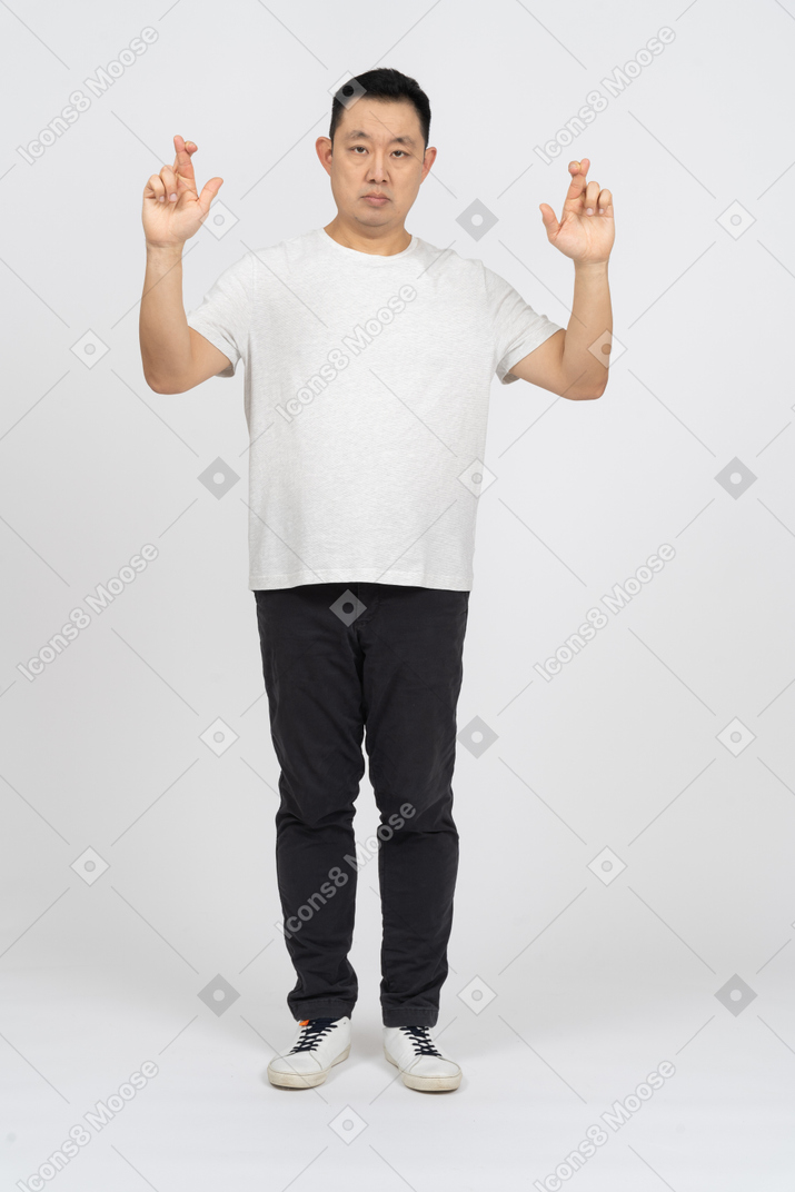 Front view of a man with crossed fingers