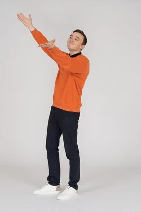 Young man in orange sweatshirt standing