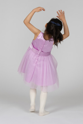 Girl in pink dress falling backwards