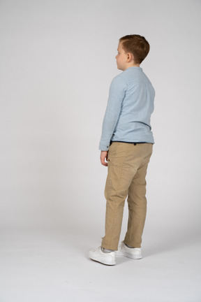 Lovely boy standing in profile