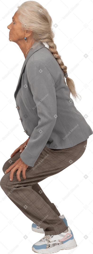 Side view of an old lady in suit squatting