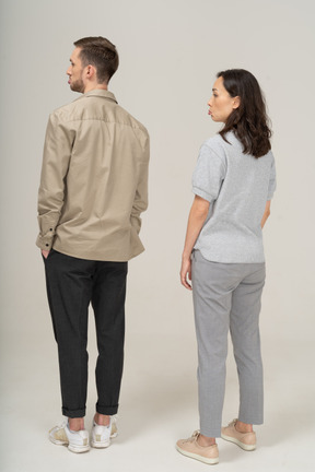 Three-quarter back view of young couple pouting