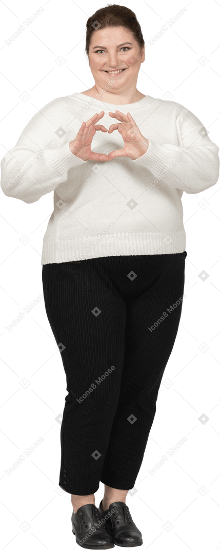 Happy plump woman in casual clothes showing heart figure