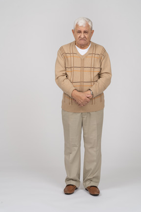 Front view of an angry old man in casual clothes