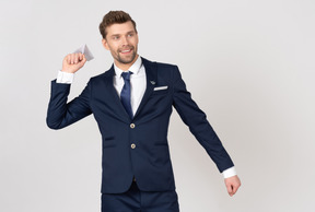 Male flight attendant holding a paper airplane