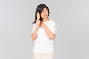 Young indian woman brushing her hair