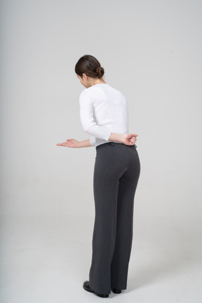 Rear view of a woman in suit gesturing