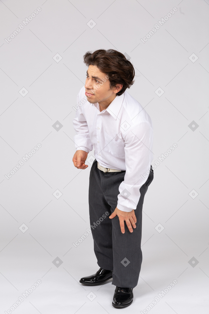 Side view of man looking aside and feeling pain in leg