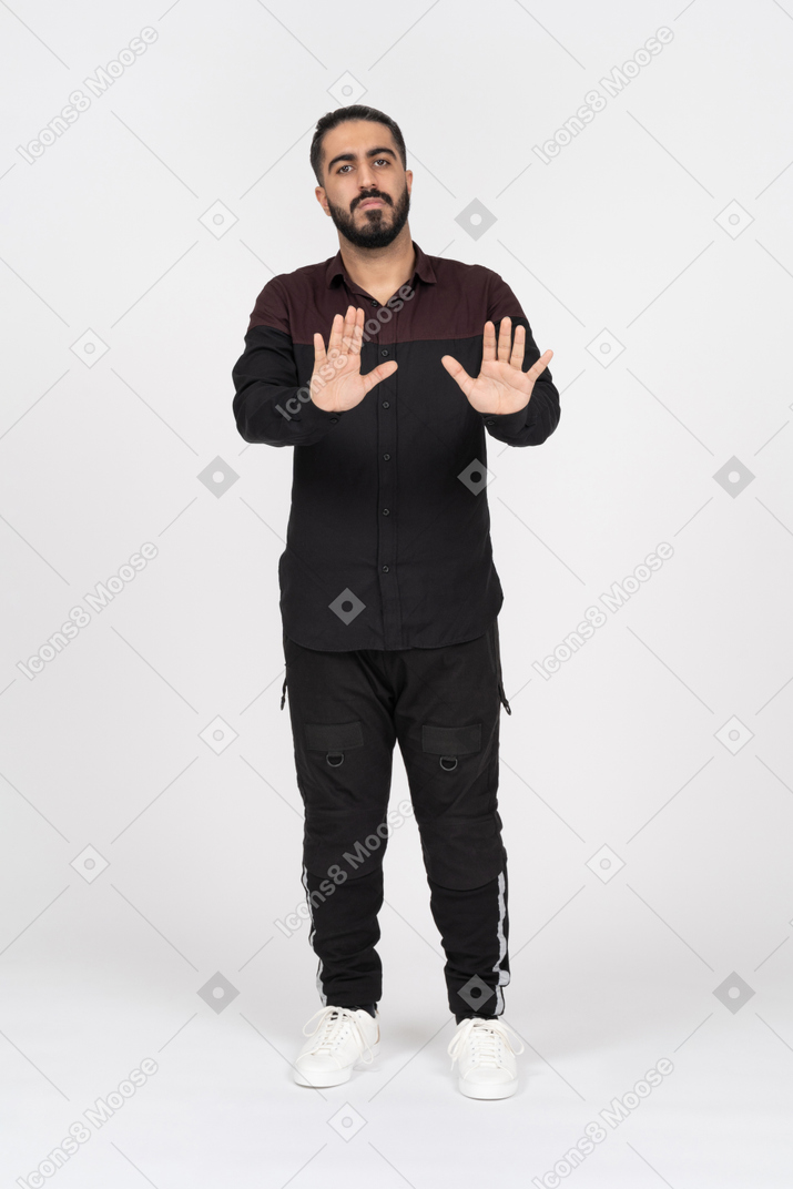 Man making stop gesture with two hands