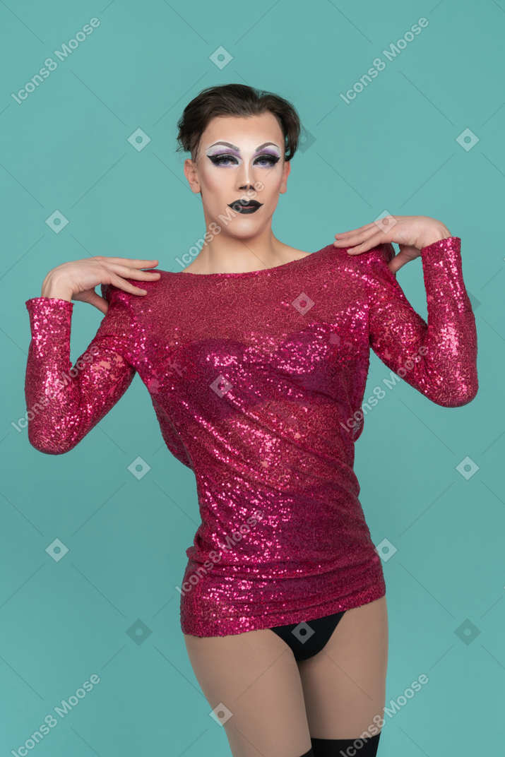 Drag queen in pink sequin dress putting hands on shoulders