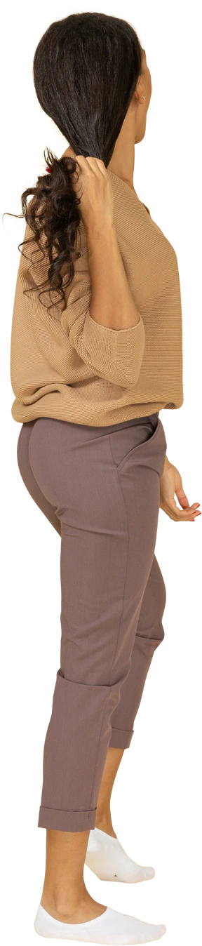 Back view of a dark-skinned young lady grabbing her hair