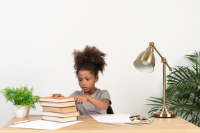 Good looking cute girl with books at the table