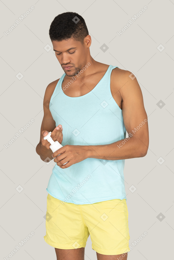 Man holding a bottle of face cream