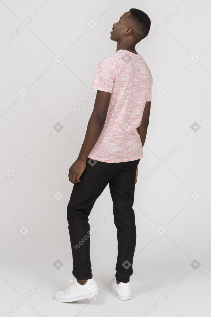 Young man standing and looking up