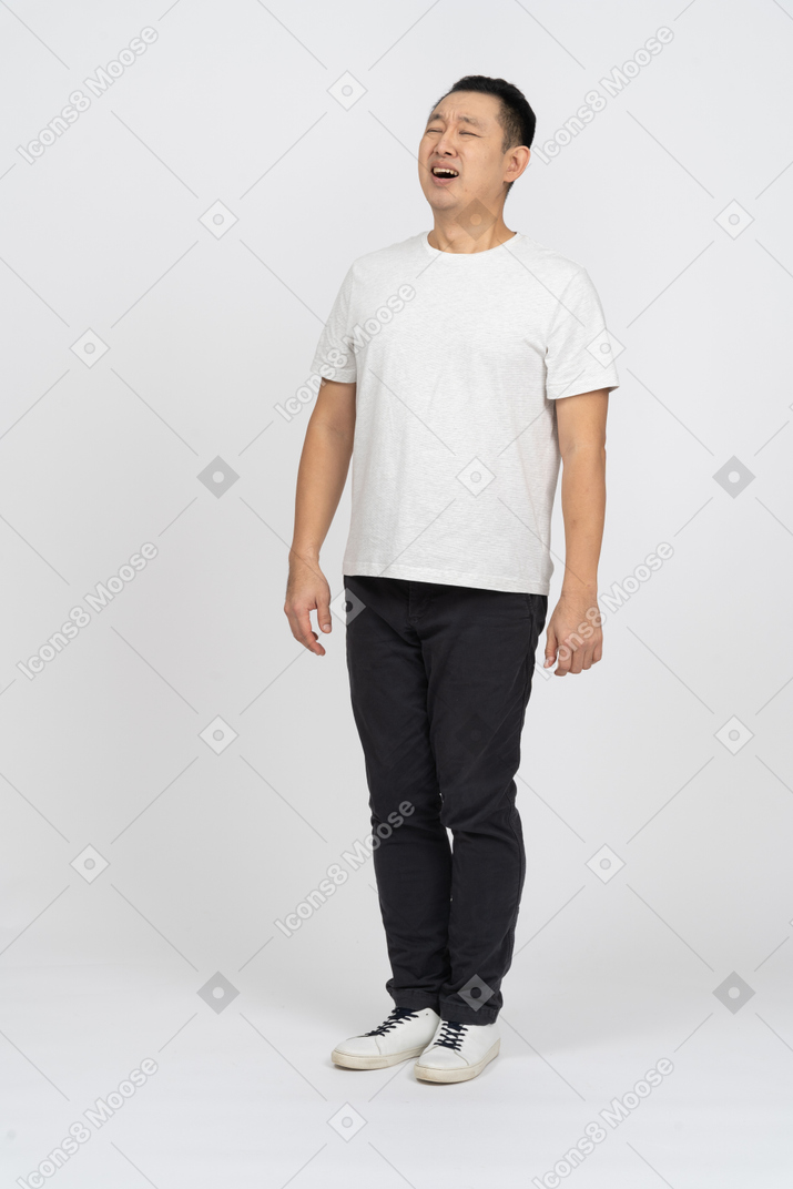 Front view of a man in casual clothes suffering from pain