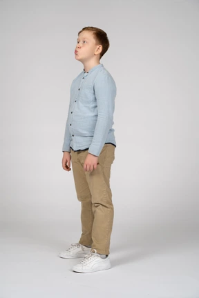 Side view of a cute boy blowing a kiss