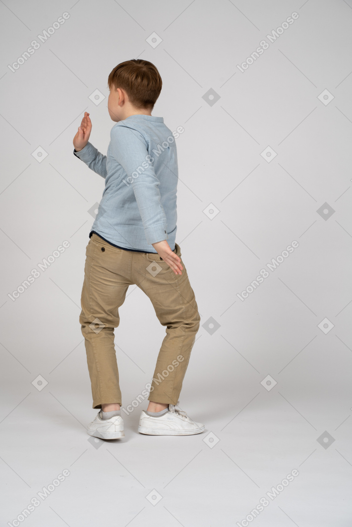 Back view of a young boy doing martial arts