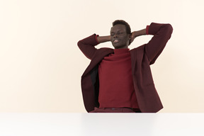 Elegant black man sitting at the table in the office