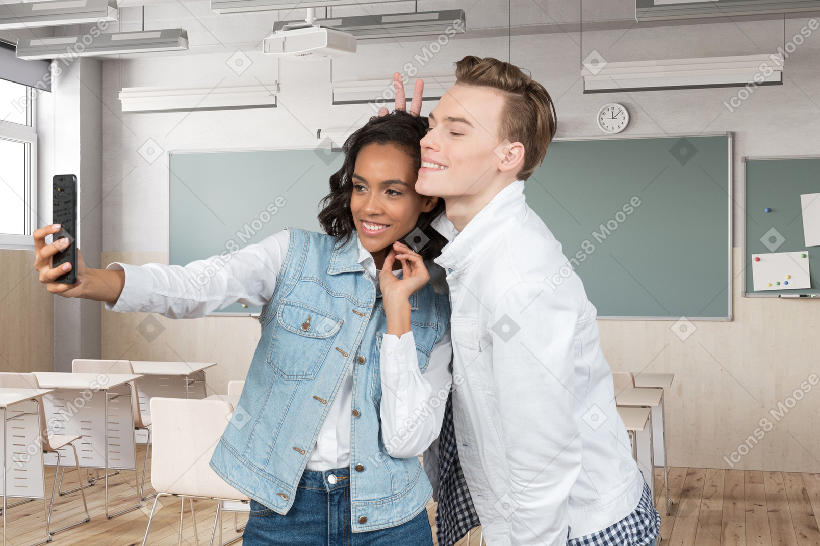 Two young people taking a selfie in a classroom