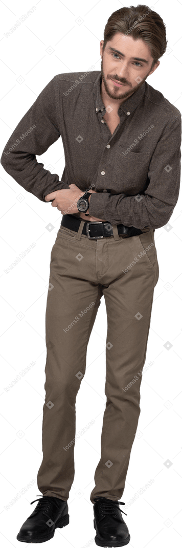 Front view of a young man in office clothing touching stomach