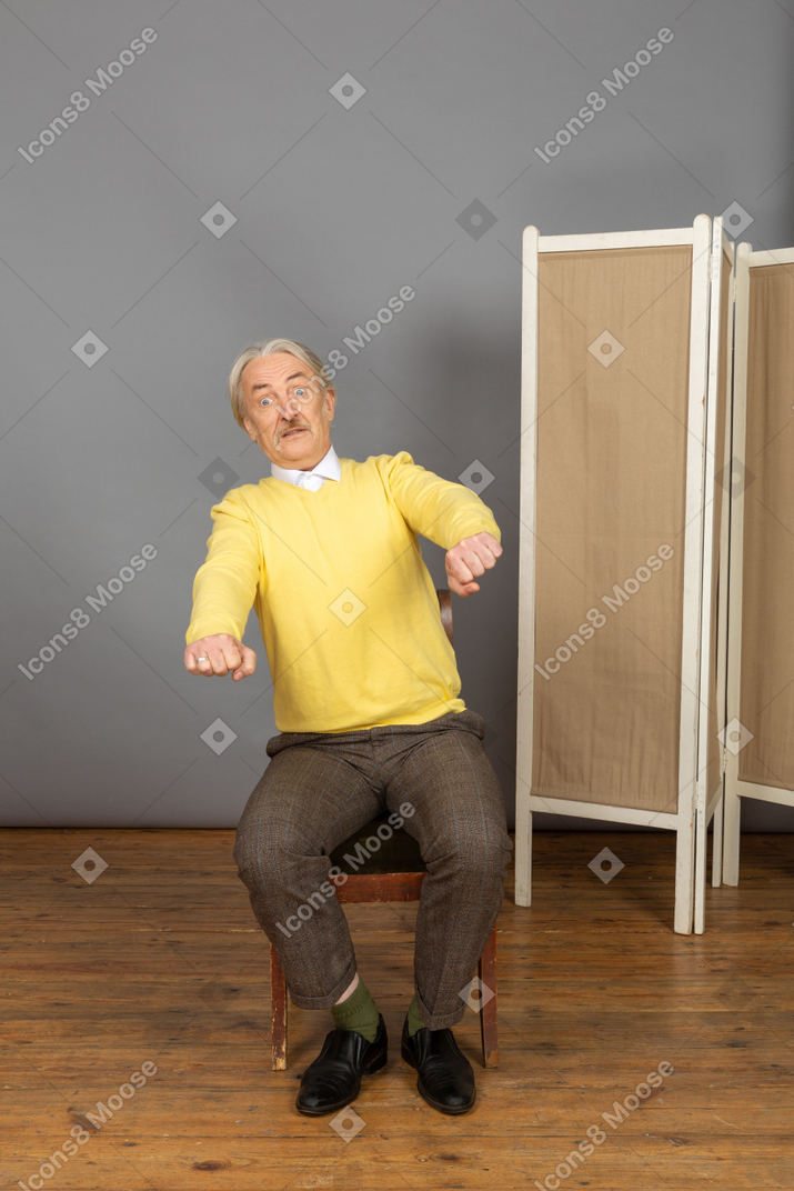 Surprised man extending his arms forward